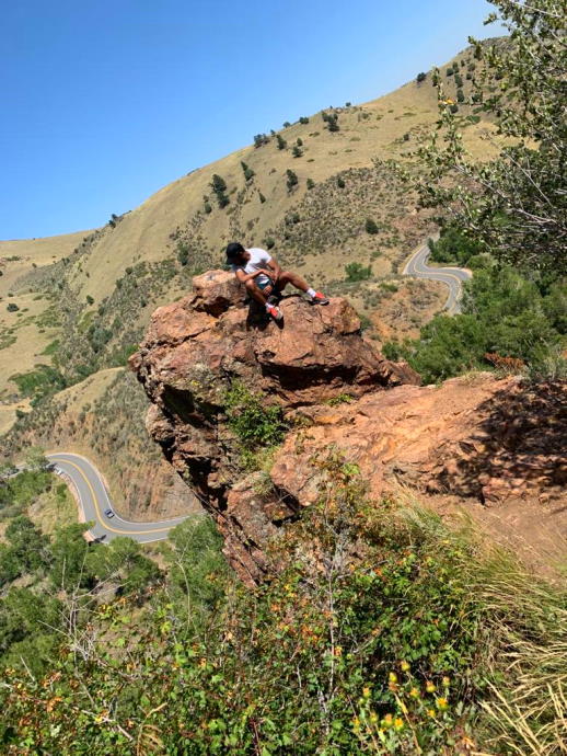 mohamed out in nature sitting on a rock