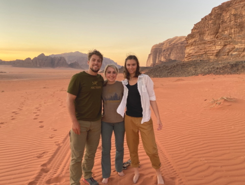 three students in the jordanian desert