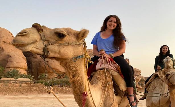 student on camel in jordan
