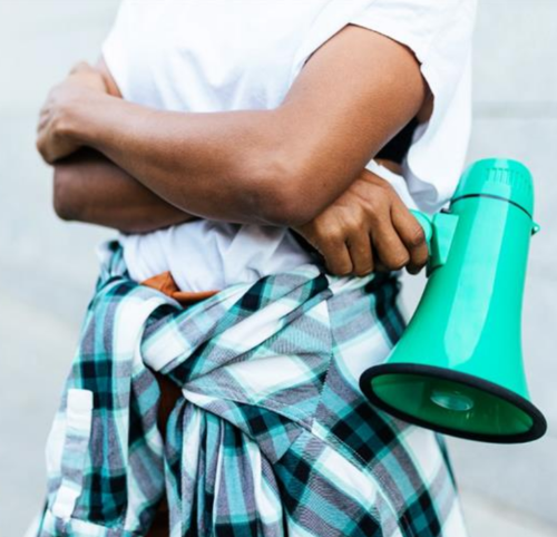 Anonymous person holding a bullhorn