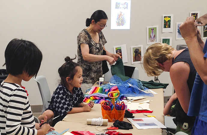 A group of student work inside a colorful space doing art.