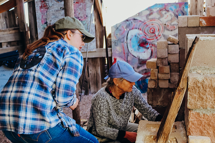 Margaret Haydon with a student wood firing