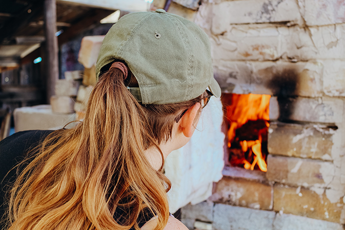 Student watching wood firing