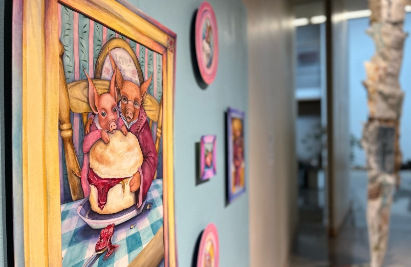 Paintings hanging up in a gallery