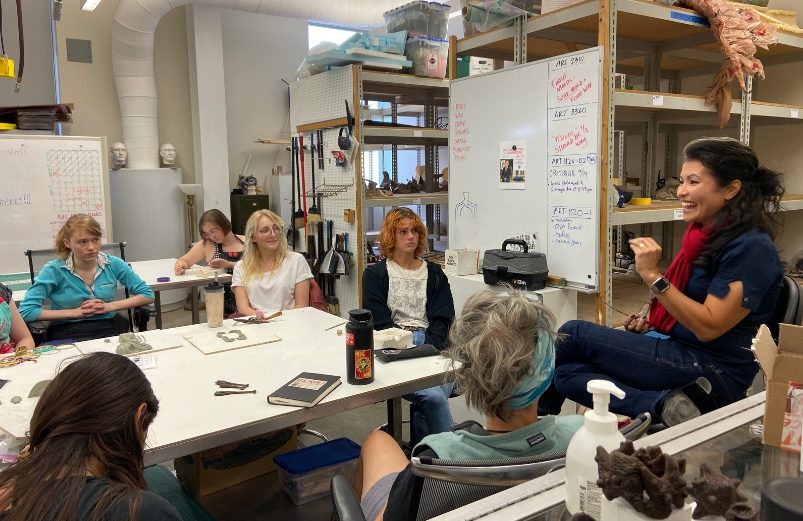 A visiting professor teaches a sculpture class