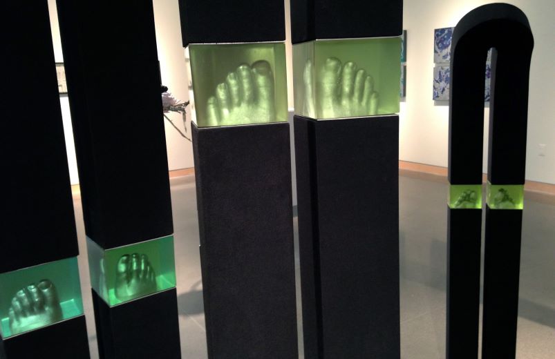 Plaster feel case in a green resin and black wooden frames.