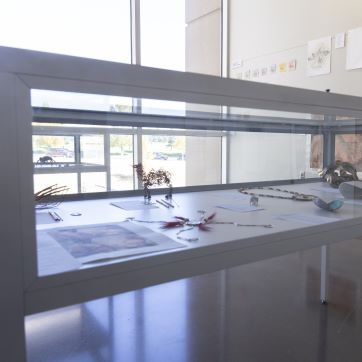 Glass case displaying metalsmith student work