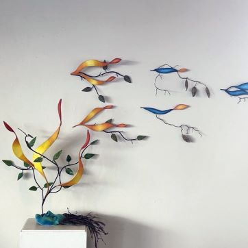 Student 3-D sculpture on pedestal and hanging on wall.