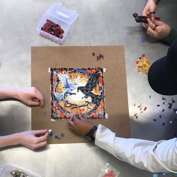 Art Students collaborate on a black and white bird mosaic