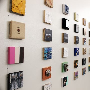 A wall of small tiles with various designs.