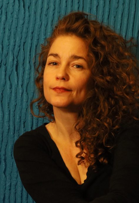 Person in front of a blue textured background.