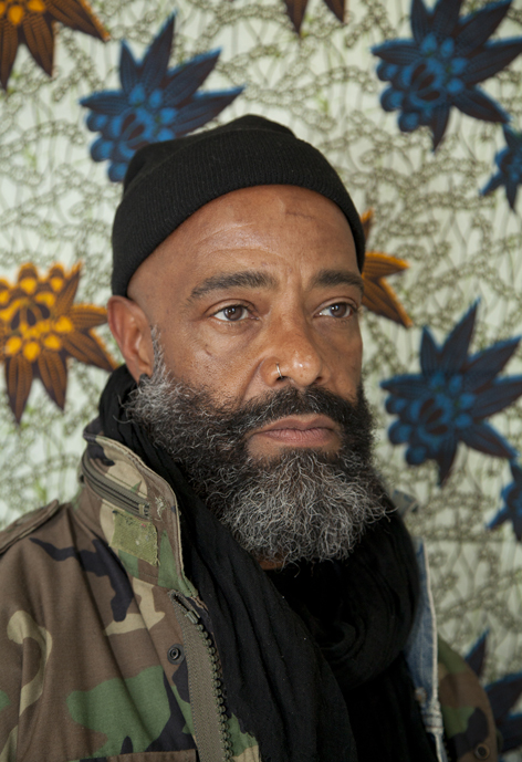 Person in front of a green textured background.