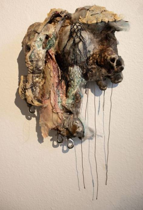 A 3-D textured sculpture of brown, tans, greens, and pinks titled "Caught in the Six, Not Too Deep.