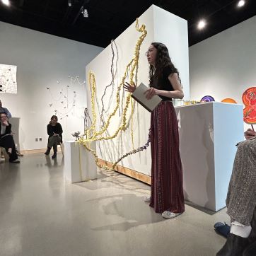 BFA art student presenting work in public defense.