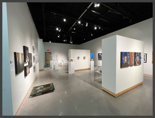 Art gallery with portraits and 3-D sculptures.