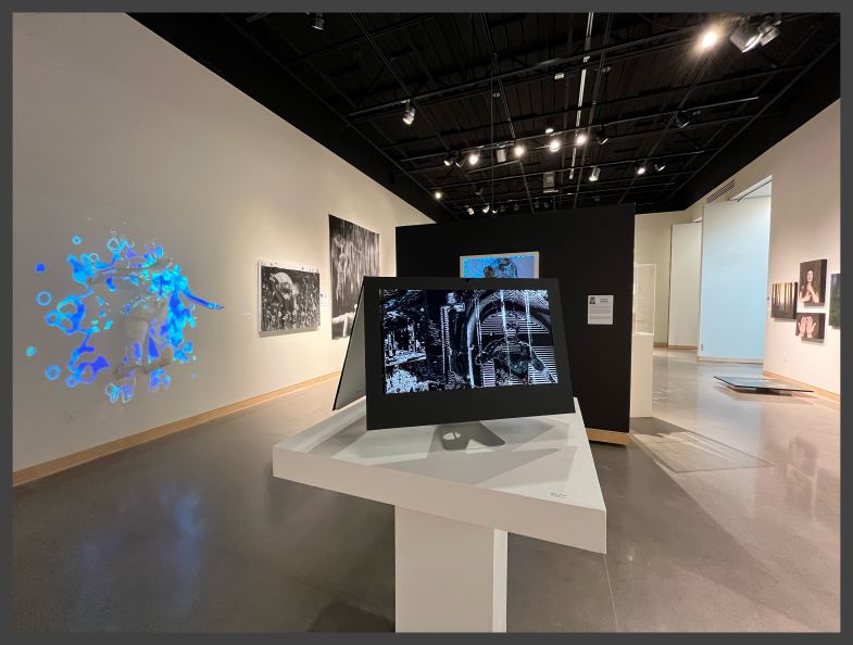 Art gallery with portraits and a digital projection on the wall