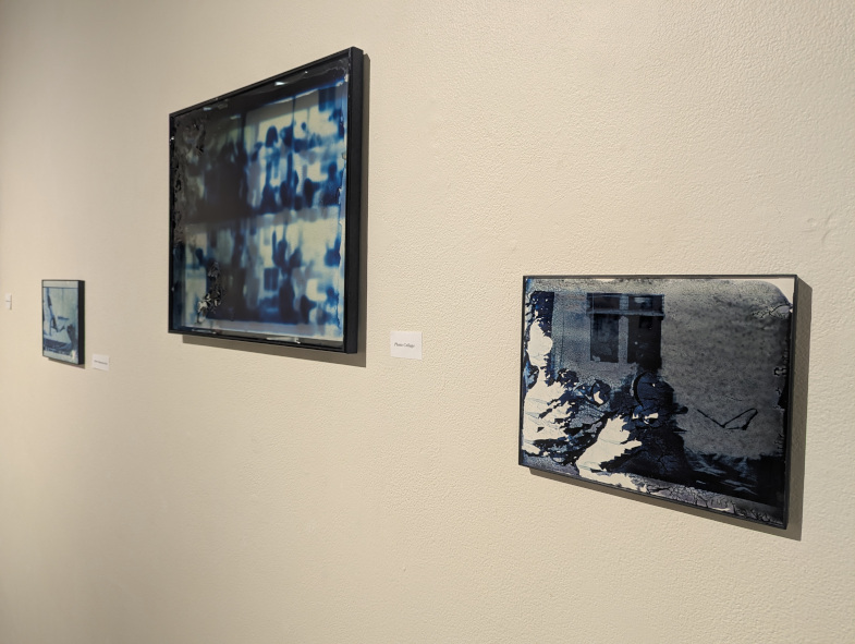 Three, abstract, blue photographs hanging on a white wall.