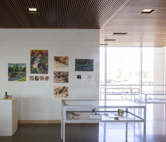 Student work displayed on walls and in cases.