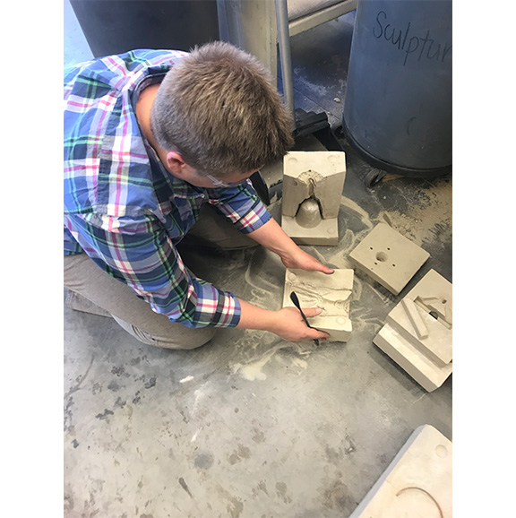 Student working with molds