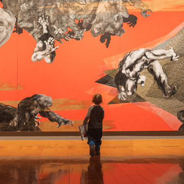 A young visitor stands in front of an art installation at the UW Art Museum.