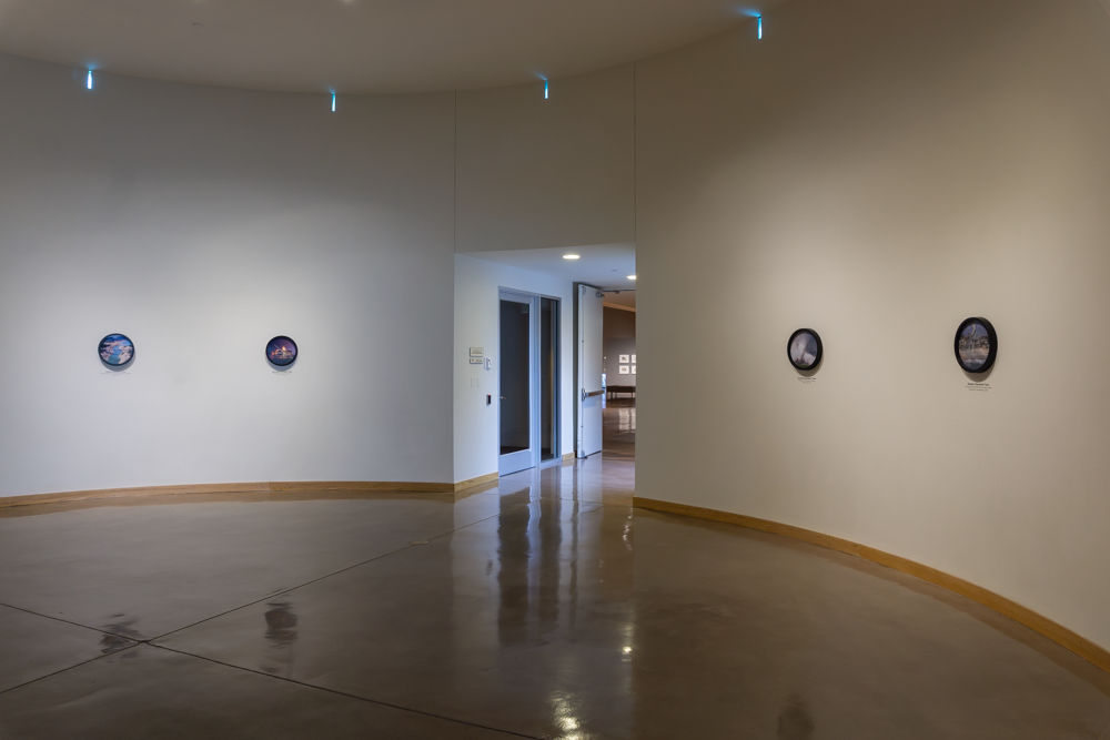 View of "Borrowed Time," a a series of six clocks, each presenting before-and-after images of natural disasters