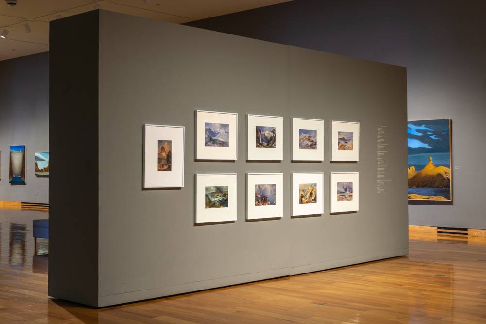 Gallery view of the "Thomas Moran" exhibition, framed prints arranged on a gray wall