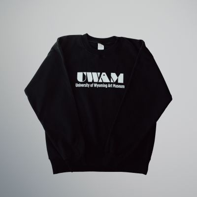 A black crewneck sweatshirt with a white UWAM logo on the front