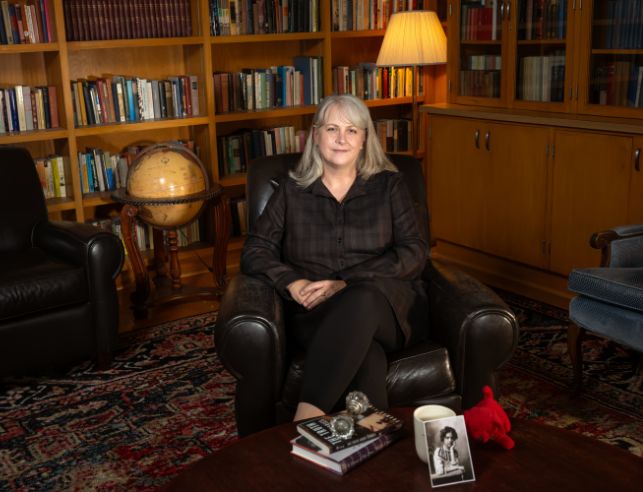 English Professor Nancy Small smiles while sitting in Hoyt Hall for the cover of the 2024 issue of Elevations.