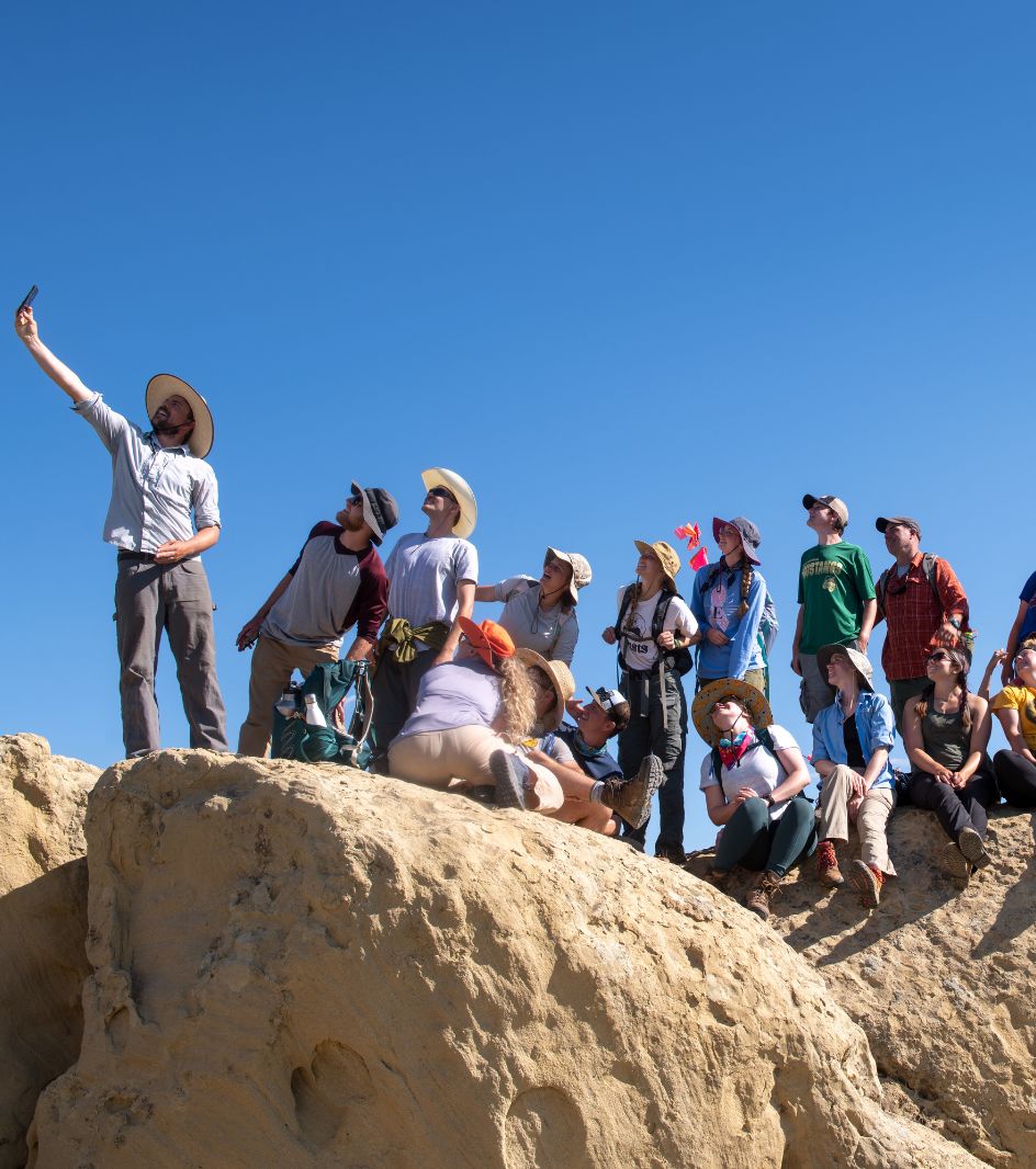 Anthropology students working in the field taking a selfie.