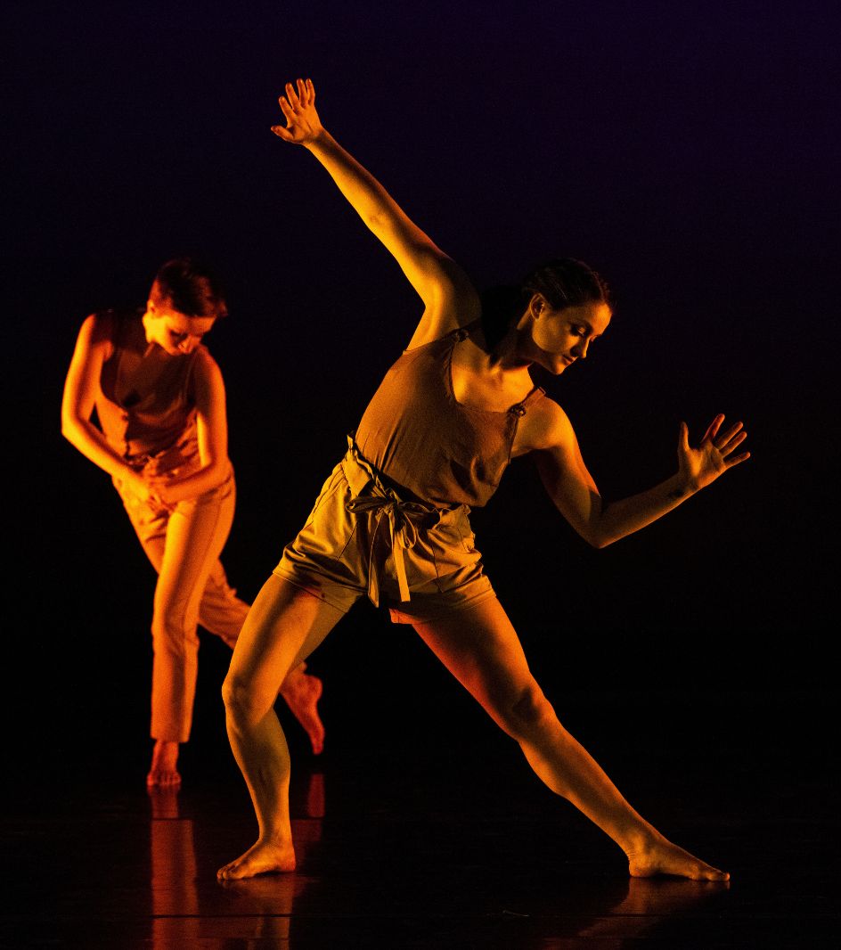 Two UW dancers perform on stage
