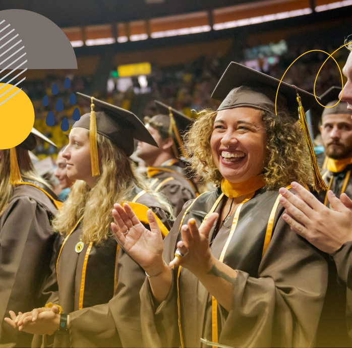 graduating students applauding at commencement