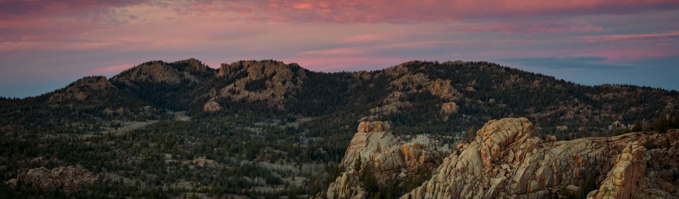 The sunsets over a mountain peak in the Happy Jack area. 