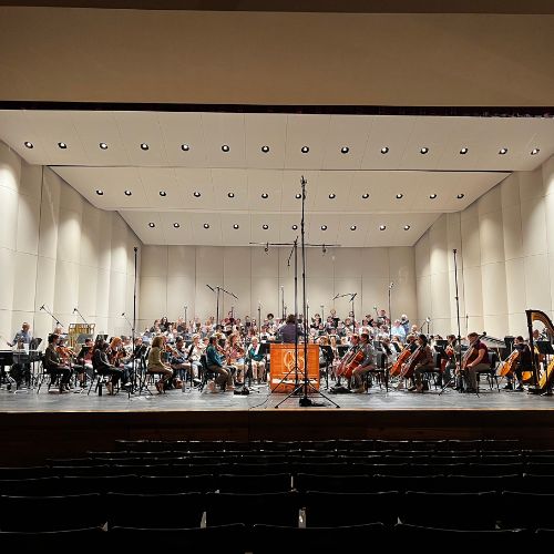 Choir members sing during a recording