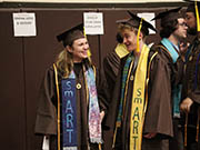 Two graduates chat before the 2025 ceremony.