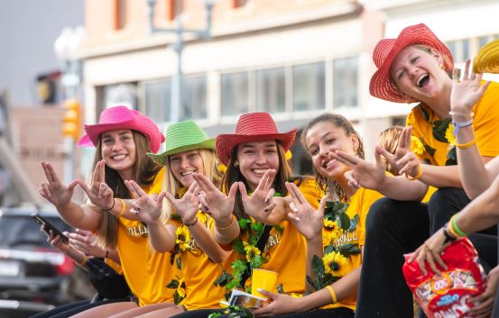Students smile during the parade during 2023 homecoming