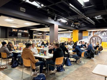 Students sitting at tables in the union during winter welcome