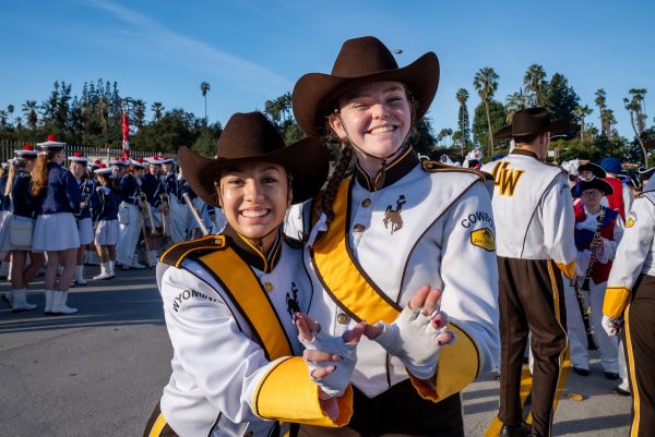 Two Western Thunder Marching Band members smile and pose.