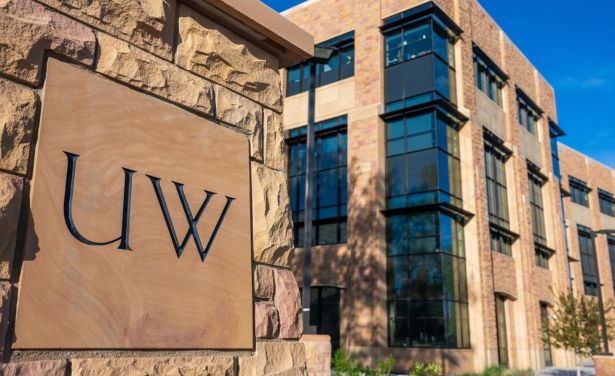 A UW logo etched in stone outside the engineering building.