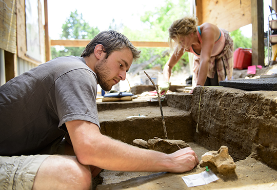 two students working on historical dig site