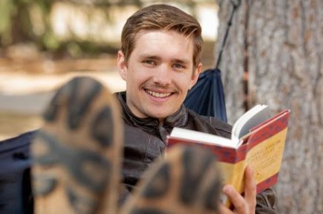 A student reads a book in a hammock