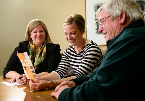 WyCOA Director Christine McKibbin works with a student and community member.