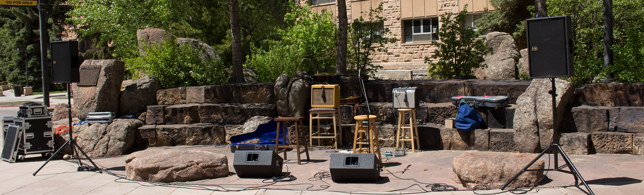 Speakers and monitors set up in front of miked amps and microphones at Simpsons Plaza