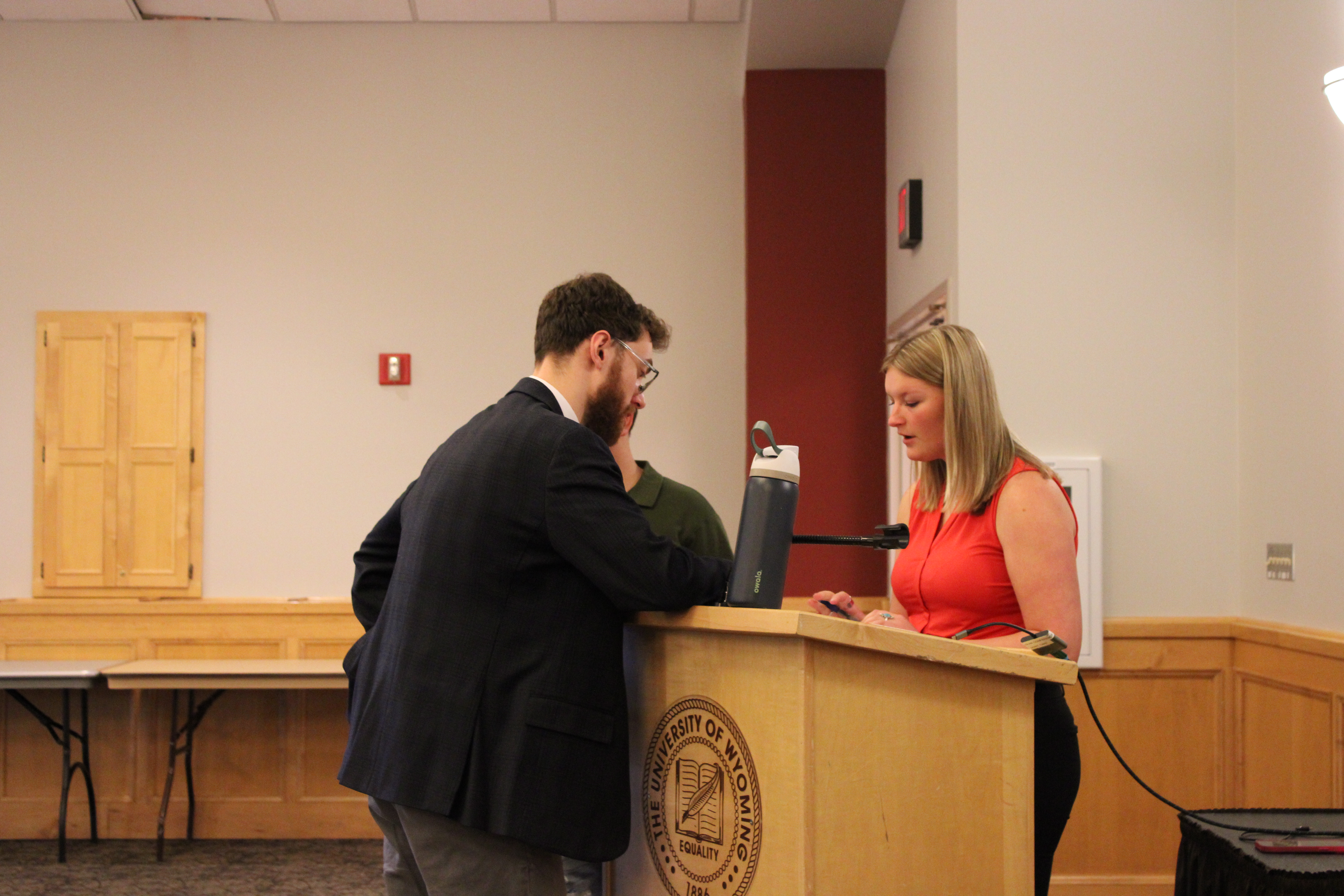 Two people speaking at a podium