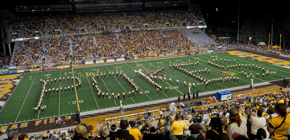 The University of Wyoming’s Western Thunder marching band spells out POKES on the field during halftime of a Wyoming Cowyboy’s football game