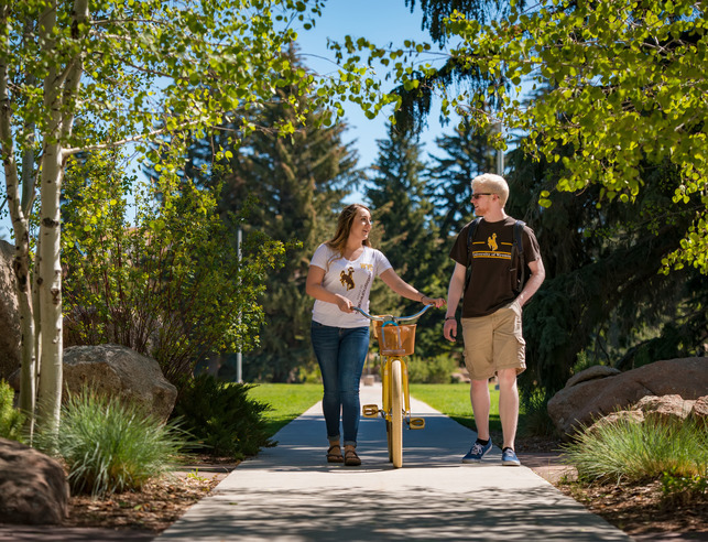 Two students walking with bike