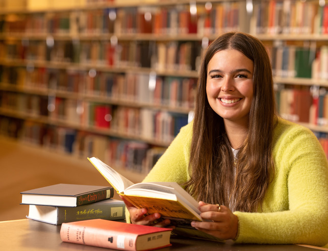 Student reading in library