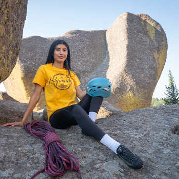Student with climbing rope and helmet