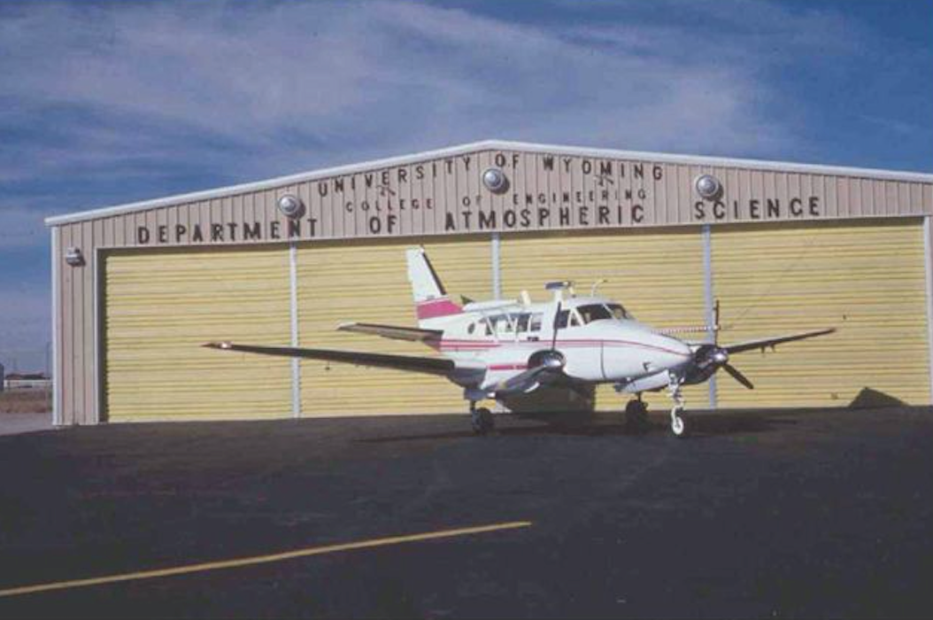 Beech Queen Airplane in front of hanger
