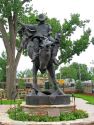 Statue in Chris LeDoux Memorial Park of cowboy on bronc.