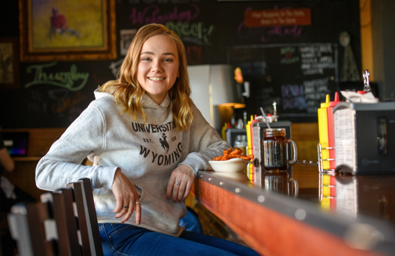 Student sits a coffee shop counter